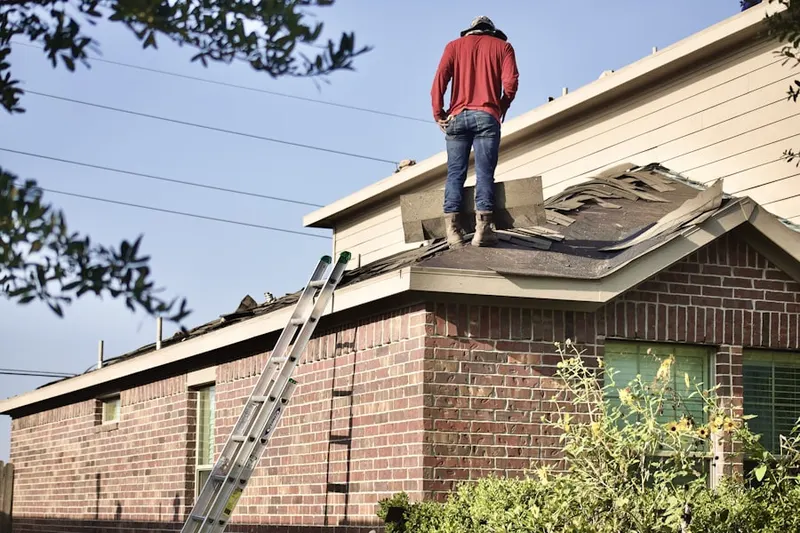 Professional roofer working on a residential roof in P.O.E.T